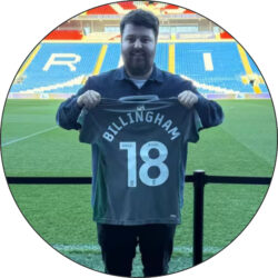 A Hunter employee holding up a Cardiff City FC women's football shirt with the name 'Billingham' on it, representing the player that Hunter sponsor with a backdrop of the Cardiff City FC stadium