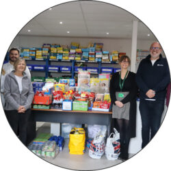 Hunter employees posing with Clevedon Foodbank volunteers at the foodbank with the donations that Hunter collected