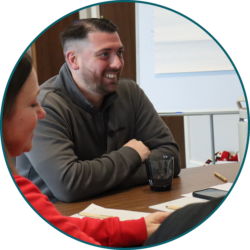 Employee contributing to a team discussion during a workplace meeting and planning session.