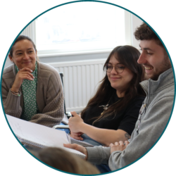 Employees collaborating in a meeting room during a team discussion and training session.